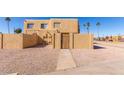 Beige stucco townhome featuring a private entrance and low-maintenance landscaping at 4650 E Wood St, Phoenix, AZ 85040