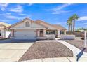 Well-maintained single-story home boasting desert landscaping, tile roof, and a welcoming front entrance at 557 S Dodge St, Gilbert, AZ 85233