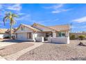 Inviting single-story home with desert landscaping, a tiled roof, and a charming walkway to the front door at 557 S Dodge St, Gilbert, AZ 85233