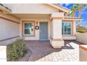 Charming front entrance featuring a decorative security door, beautiful brick pavers, and desert landscaping at 557 S Dodge St, Gilbert, AZ 85233