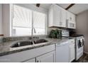 Bright kitchen featuring granite countertops, stainless steel sink, and white appliances at 652 S Ellsworth Rd # 92, Mesa, AZ 85208