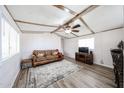 Cozy living room featuring wood-look flooring, ceiling fan, and a comfortable sofa at 652 S Ellsworth Rd # 92, Mesa, AZ 85208