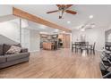Open-concept living space with wood floors, exposed beam, a dining area, and a kitchen at 796 E Pepper Dr, Casa Grande, AZ 85122