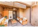 Inviting outdoor patio with comfortable wicker furniture, a ceiling fan, and shaded privacy screens at 796 E Pepper Dr, Casa Grande, AZ 85122