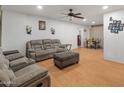 Spacious living room with laminate flooring and comfortable seating area at 8540 N 104Th Ave, Peoria, AZ 85345