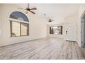 Light-filled living room with vaulted ceiling boasts modern floors, neutral paint, and ample natural light at 11318 S Hopi Dr, Goodyear, AZ 85338