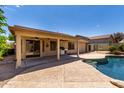 A covered patio area with fans, a grill and access to the backyard swimming pool at 11318 S Hopi Dr, Goodyear, AZ 85338