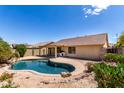 A beautifully landscaped backyard with a sparkling pool, perfect for relaxing and entertaining at 11318 S Hopi Dr, Goodyear, AZ 85338