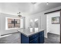 Bright kitchen with a modern island, elegant light fixture, and open layout at 11359 E Elena Ave, Mesa, AZ 85208