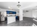 Open concept kitchen featuring stainless steel appliances and an adjacent living area at 11359 E Elena Ave, Mesa, AZ 85208