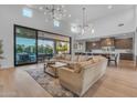 Bright living area with sliding glass doors opening to a patio and connecting to the modern kitchen at 12034 N 61St St, Scottsdale, AZ 85254