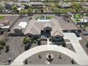 Expansive aerial view of the property showcases the sprawling lot, desert landscaping, pool and surrounding neighborhood at 14507 W Christy Dr, Surprise, AZ 85379
