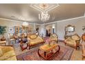 Opulent living room featuring elegant furnishings, ornate details, and a sophisticated ambiance for formal entertaining at 14507 W Christy Dr, Surprise, AZ 85379