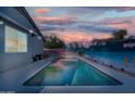 Inviting backyard features a refreshing swimming pool and mural-covered walls for enhanced privacy at 1700 W Paisley Dr, San Tan Valley, AZ 85144