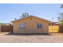Small single-story house with a tan exterior, minimal landscaping, and marked with the number 207 at 207 E Cedar Ave, Casa Grande, AZ 85122