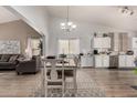 Open-concept living and dining area featuring wood floors and bright, natural light at 23830 W Chambers St, Buckeye, AZ 85326