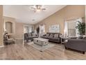 Spacious living room with vaulted ceilings, wood floors, and neutral decor at 23830 W Chambers St, Buckeye, AZ 85326