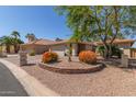 Charming home featuring desert landscaping, brick accents, and a well-manicured yard at 26450 S Shumaker Dr, Sun Lakes, AZ 85248