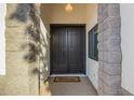 Close-up of home's welcoming double front door with a stone entryway and welcome mat at 3019 E Redfield Rd, Phoenix, AZ 85032
