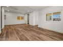 Spacious, bright living room with wood-look flooring and multiple windows for natural light at 3104 E Broadway Rd -- # 287, Mesa, AZ 85204
