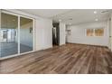 Open layout living room featuring wood-look floors and sliding door access to the screened-in patio at 3104 E Broadway Rd -- # 287, Mesa, AZ 85204