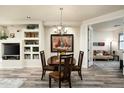 This dining area features a wooden table with four chairs adjacent to built-in shelving and an adjacent living area at 34457 N Legend Trail Pkwy # 1003, Scottsdale, AZ 85262