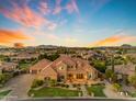 Expansive desert home featuring manicured landscaping, mature trees and hardscape at 3446 E Knoll St, Mesa, AZ 85213