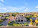 Luxury home with manicured landscaping, mature trees and hardscape in a lush desert neighborhood at 3446 E Knoll St, Mesa, AZ 85213
