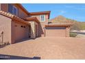 Attractive two story home with brick driveway and three car garage, on a sunny day at 34714 N 21St Ln, Phoenix, AZ 85086