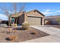 Charming single-story home with a two-car garage and low-maintenance landscaping on a sunny day at 3654 E Henson St, San Tan Valley, AZ 85140