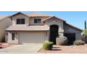 Charming two-story home featuring a front-facing garage and desert-style landscaping at 4150 E Harvard Ave, Gilbert, AZ 85234