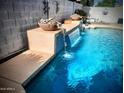Backyard pool showcasing a stacked stone water feature adding a touch of elegance and tranquility to the outdoor space at 4150 E Harvard Ave, Gilbert, AZ 85234
