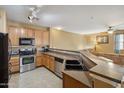 Open kitchen layout with stainless steel appliances and breakfast bar at 4769 E Thunderheart Trl # 101, Gilbert, AZ 85297