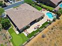Expansive backyard oasis featuring a sparkling pool, spa, putting green, and multiple seating areas at 6044 E Hodges St, Cave Creek, AZ 85331