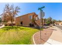 Corner lot home with a manicured front yard and a two car garage featuring desert landscaping at 617 N Cobblestone St, Gilbert, AZ 85234