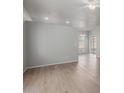 Bright and airy living room featuring light wood flooring, gray walls, and a modern ceiling fan at 625 N Hamilton St # 36, Chandler, AZ 85225