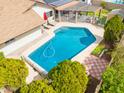 Backyard featuring a pool, solar panels, patio with pergola, and landscaped yard at 6409 W Riviera Dr, Glendale, AZ 85304