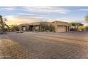 Charming home boasts desert landscaping and a spacious driveway at 7603 E Soaring Eagle Way, Scottsdale, AZ 85266