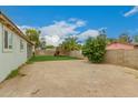 Large backyard offers plenty of space for activities, with a play structure on artificial grass at 7605 W Avalon Dr, Phoenix, AZ 85033
