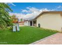 Backyard view showcases grass, and part of a play structure, perfect for families at 7605 W Avalon Dr, Phoenix, AZ 85033