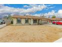 Inviting single-story home featuring a side view, complemented by a carport for convenient parking at 7605 W Avalon Dr, Phoenix, AZ 85033