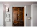 Front door of unit 309 featuring updated hardware and decorative wall accents at 7860 E Camelback Rd # 309, Scottsdale, AZ 85251
