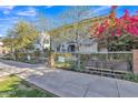 Attractive gray two-story home with a gray iron gate, complemented by a fence of colorful pink flowers at 841 N 2Nd Ave # 104, Phoenix, AZ 85003