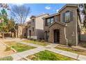 Attractive townhomes with decorative brick entryways, tidy lawns, and sidewalk access at 9233 E Neville Ave # 1138, Mesa, AZ 85209