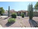 Single-story home featuring desert landscaping, gravel, cacti and a two car garage at 9763 W Butler Dr, Peoria, AZ 85345