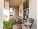 Inviting front porch with a cozy seating area overlooking the beautiful community landscape at 10657 E Texas Ave, Mesa, AZ 85212