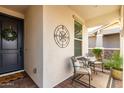 Inviting front porch with a cozy seating area perfect for enjoying the outdoors at 10657 E Texas Ave, Mesa, AZ 85212