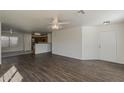 Inviting open-concept living room with wood floors, a ceiling fan, and an adjoining kitchen area at 1615 W Hidalgo Ave, Phoenix, AZ 85041