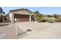 Well-maintained home with desert landscaping, concrete driveway, and attached garage at 16913 W Cortaro Point Dr, Surprise, AZ 85387
