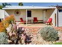 Covered porch features seating, stone landscaping, and desert vegetation at 17200 W Bell Rd # 2221, Surprise, AZ 85374